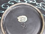 a black plate with a blue and white design on it