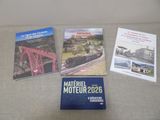 three books on a couch with a train in the background