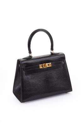 a black leather handbag on a white background