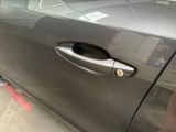 a close up of a car door handle with a sticker on it