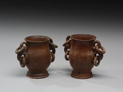 deux vases marron posés l'un à côté de l'autre sur une table