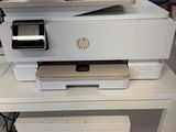a white printer sitting on top of a white desk