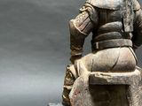 a statue of a man sitting on a rock