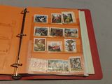 a red binder with a bunch of stamps on it