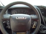 a steering wheel and dashboard of a vehicle in a parking lot