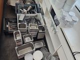 a kitchen with a lot of dishes and pans on the counter