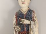 a statue of a woman with a dog on a table