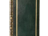 an old green book with a gold border on a white background