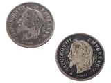 a close up of two silver coins on a white surface