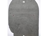 a grey stone plaque with a circular design on it