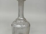 a glass bottle with a stopper on top of it