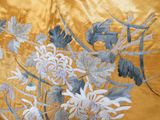 a picture of a gold and blue floral design on a gold background