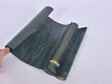 a person that is holding a roll of black paper