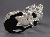 a silver ring with a black and white design on it