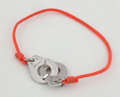 un bracelet en fil rouge orné de deux menottes
