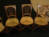 three wooden chairs sitting next to each other on a black background