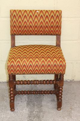 a wooden chair with a red and yellow pattern on it