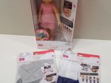 doll in a box with clothing and accessories on a table