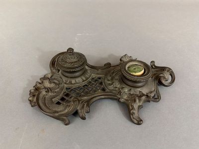 a metal object with a clock on it on a table