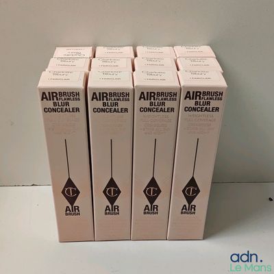 four boxes of airbrushes sitting on top of a white table
