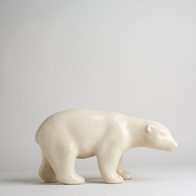 a white polar bear figurine on a white surface