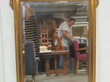 a man standing in front of a mirror in a room