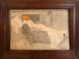 an old picture of a woman laying on a couch in a living room