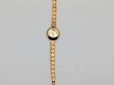 a gold wrist watch with a black face and a white face