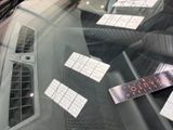 stickers on the windshield of a car that has a keyboard on it