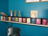 a shelf that has various types of teas on it
