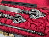 two knives in a case on a red cloth
