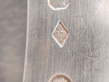 a close up of a silver plate with four small coins on it