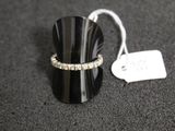 a ring that is sitting on a table next to a price tag