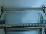a glass shelf with a mirror on top of it