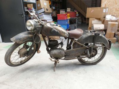 a old motorcycle that is parked in a garage