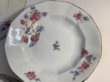 three plates and a bowl sitting on a table