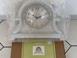 a box with a clock inside of it on the floor