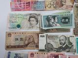 a lot of different foreign currency on the table