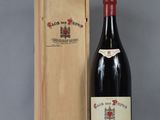 an old bottle of wine sitting next to a wooden box