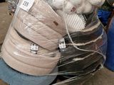 a pile of mattresses sitting on a pallet in a warehouse