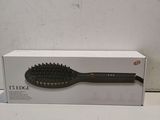 an image of a hair brush sitting on top of a box