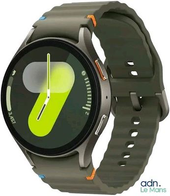 a smart watch with a green face and yellow hands