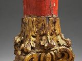 an image of a red and gold vase sitting on top of a table