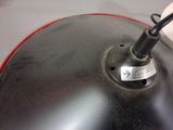 a close up of a black and red lamp on a table