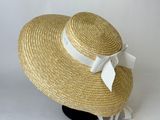 beige straw hat with white ribbon and bow