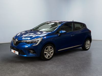 a blue car is parked in a room with a white wall
