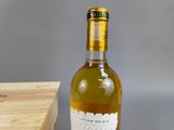a bottle of wine sitting on a table next to a box