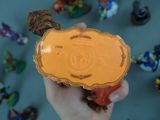 a person holding a small orange object in their hand