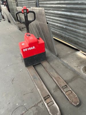 a forklift that is sitting in front of a building