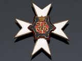 a badge with a crown on it on a black surface